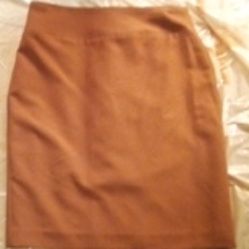 Ladies tan midi skirt with a little slit in the ba